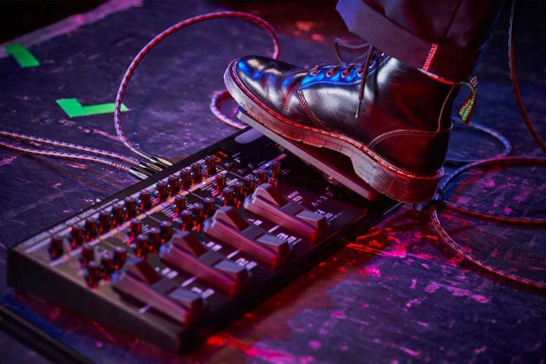 A guitarist using a ME90 multi effects processor made by Boss