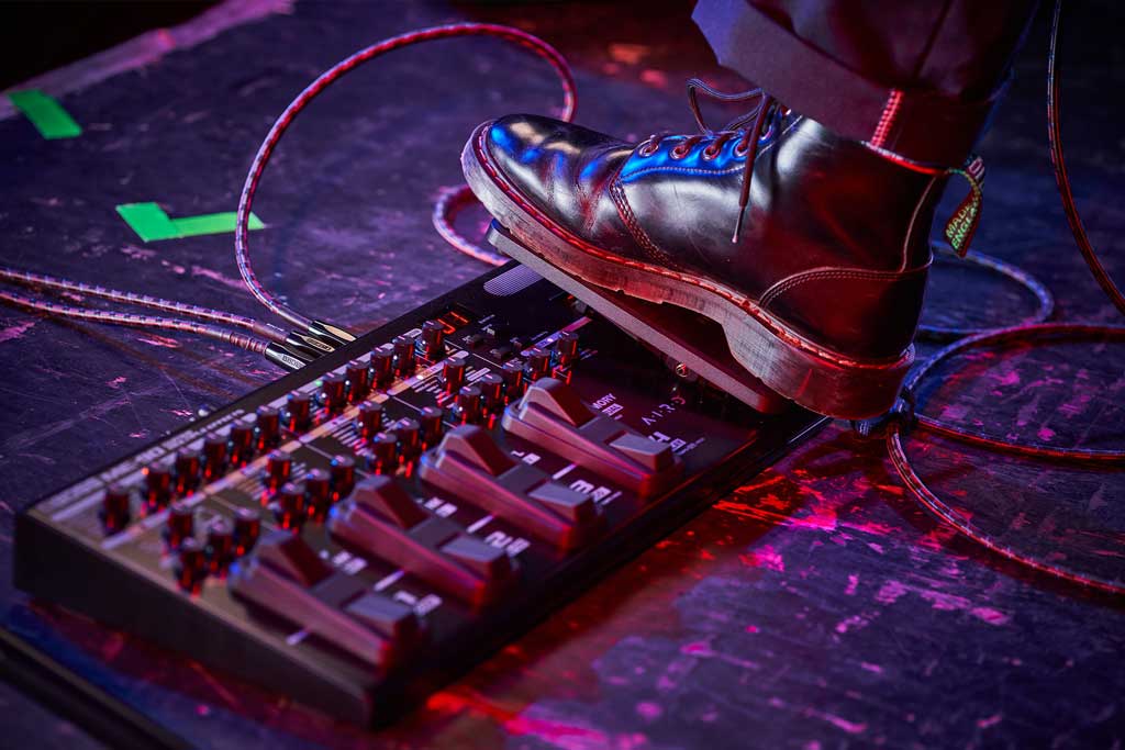A guitarist using a ME90 multi effects processor made by Boss