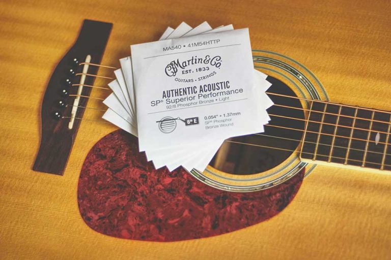 A Martin acoustic guitar and some Martin strings sets