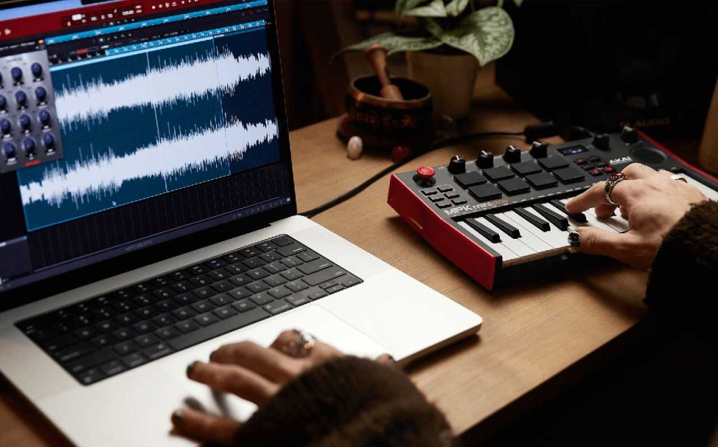 An AKAI MPK keyboard paired with DAW software