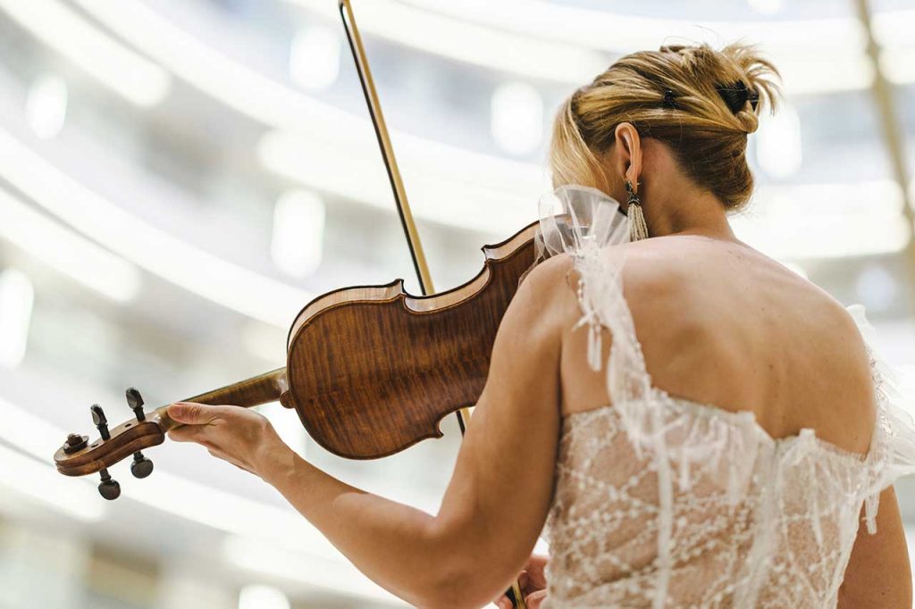 A violinist playing a maple violin